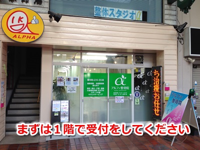 1階のアルファー整骨院で受付してください